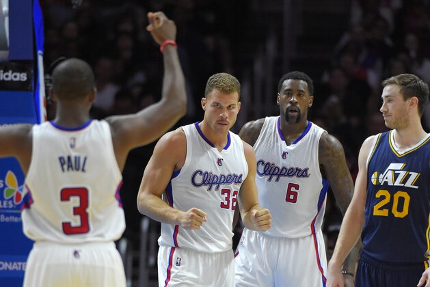 Los Angeles Clippers forward Blake Griffin, second from left, celebrates after scoring with guard Chris Paul, left, and center DeAndre Jordan, second from right, as Utah Jazz guard Gordon Hayward looks on during the second half of an NBA basketball game, Monday, Nov. 3, 2014, in Los Angeles. The Clippers won 107-101. (AP Photo/Mark J. Terrill)