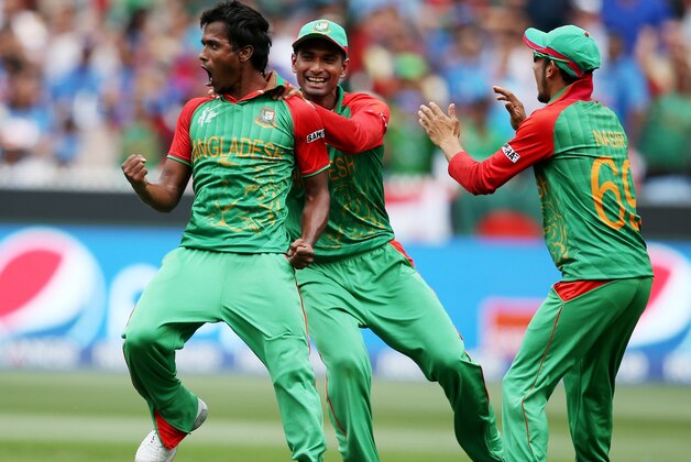 Bangladesh’s Rubel Hossain, left, celebrates with teammate Mahmudullah and Nasir Hossain, right, after taking the wicket of India's Virat Kohli during their Cricket World Cup quarterfinal match in Melbourne, Australia, Thursday, March 19, 2015. (AP Photo/Rick Rycroft)