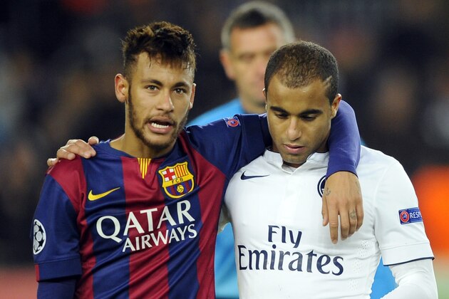 Barcelona's Neymar, left, leaves the pitch with PSG's Lucas at the end of the Group F Champions League soccer match between FC Barcelona and PSG at the Camp Nou stadium in Barcelona, Spain, Wednesday Dec. 10, 2014. Lionel Messi, Neymar and Luis Suarez all scored to lead Barcelona to a thrilling 3-1 comeback win over Paris Saint-Germain on Wednesday, as the Spanish club snatched first place in Group F of the Champions League from the French side. (AP Photo/Manu Fernandez)