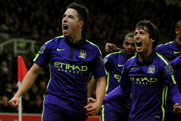 Manchester City's Samir Nasri, left, and David Silva celebrate towards fans after James Milner scored against Stoke during the English Premier League soccer match between Stoke City and Manchester City at the Britannia Stadium, in Stoke on Trent, England, Wednesday, Feb. 11, 2015. (AP Photo/Rui Vieira)