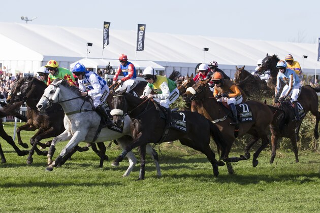 Horses including the eventual winner Many Clouds ridden by Leighton Aspell, centre left, clear the Chair jump during the Grand National horse race at Aintree Racecourse Liverpool, England, Saturday, April 11, 2015. (AP Photo/Jon Super)