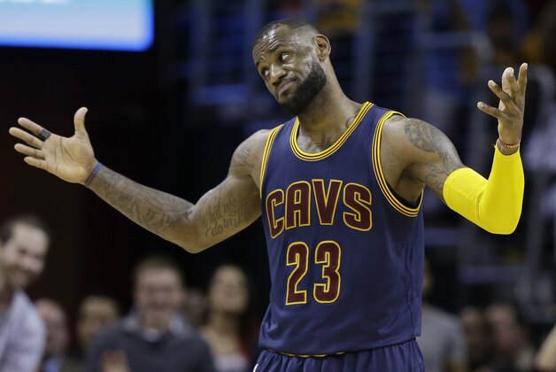 Cleveland Cavaliers' LeBron James reacts after a 3-point shot by Kyrie Irving during the third quarter of an NBA basketball game Sunday, April 5, 2015, in Cleveland. The Cavaliers defeated the Bulls 99-94. (AP Photo/Tony Dejak)