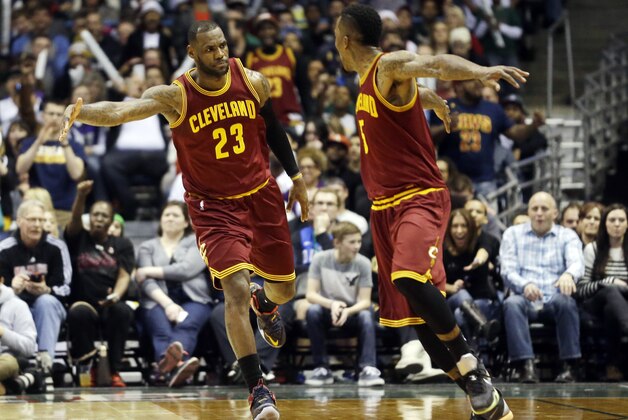 Cleveland Cavaliers' LeBron James (23) celebrates with teammate J.R. Smith after making a basket during the second half of an NBA basketball game against the Milwaukee Bucks, Sunday, March 22, 2015, in Milwaukee. (AP Photo/Morry Gash)