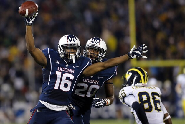Sep 21, 2013; East Hartford, CT, USA; Connecticut Huskies cornerback Byron Jones (16) reacts after intercepting a pass intended for Michigan Wolverines wide receiver Jehu Chesson (86) in the second quarter at Rentschler Field. Mandatory Credit: David Butler II-USA TODAY Sports