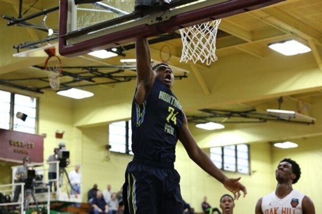 Huntington Prep's Thomas Bryant #24 dunks against Oak Hill Academy in the DICK'S Sporting Goods High School National Basketball Tournament on Friday, April  3, 2015 in Queens, NY. Oak Hill Academy won the game to advance to the finals.  (AP Photo/Gregory Payan)