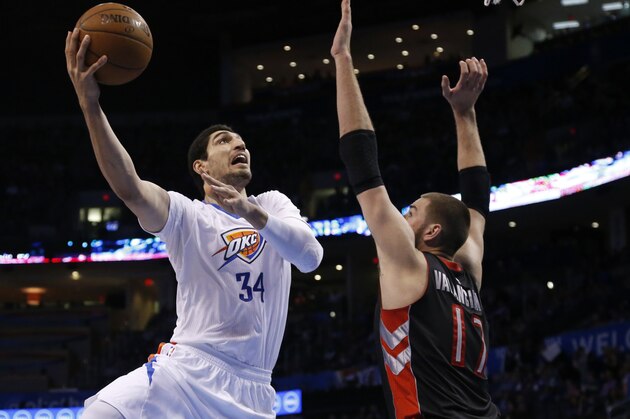 Oklahoma City Thunder center Enes Kanter (34) shoots as Toronto Raptors center Jonas Valanciunas (17) defends during an NBA basketball game between the Toronto Raptors and the Oklahoma City Thunder in Oklahoma City, Sunday, March 8, 2015. (AP Photo/Sue Ogrocki)