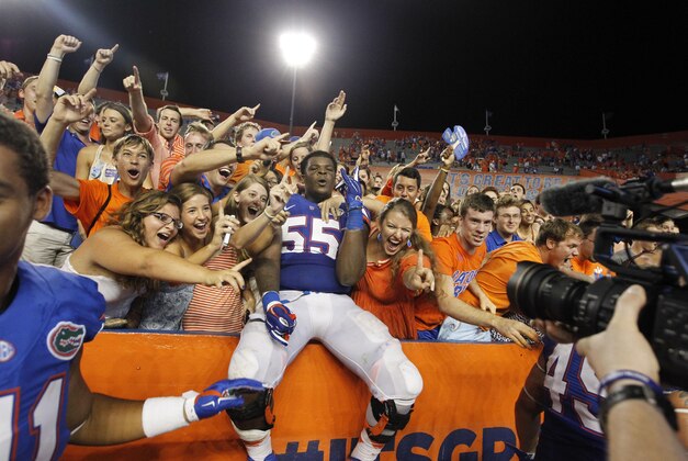 Sep 13, 2014; Gainesville, FL, USA; Florida Gators offensive linesman Roderick Johnson (55) celebrates with fans after they beat the Kentucky Wildcats during overtime at Ben Hill Griffin Stadium. Florida Gators defeated the Kentucky Wildcats 36-30 in triple overtime. Mandatory Credit: Kim Klement-USA TODAY Sports