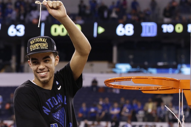 Duke's Tyus Jones cuts down the net after his team's 68-63 victory over Wisconsin in the NCAA Final Four college basketball tournament championship game Monday, April 6, 2015, in Indianapolis. (AP Photo/David J. Phillip)