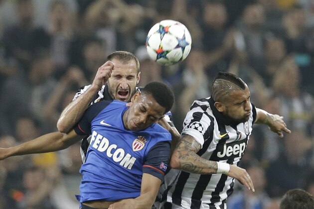 Monaco's Anthony Martial, left, goes for a header with Juventus players Giorgio Chiellini and Arturo Vidal, right, during the Champions League quarterfinal first leg soccer match between Juventus and Monaco at the Juventus stadium in Turin, Italy, Tuesday, April 14, 2015. (AP Photo/Antonio Calanni)