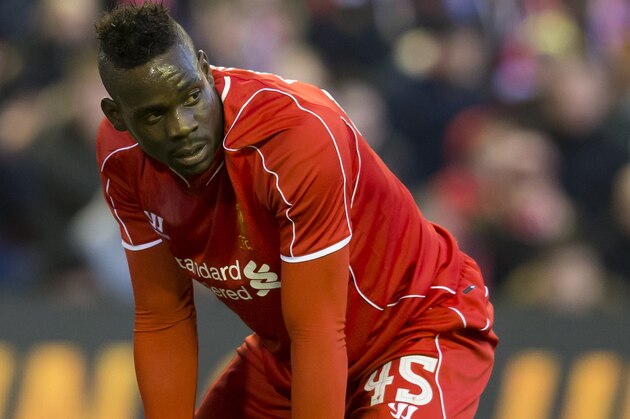 Liverpool's Mario Balotelli kneels on the pitch after a missed opportunity during his team's English FA Cup quarter final soccer match between Liverpool and Blackburn at Anfield Stadium, Liverpool, England, Sunday March 8, 2015. (AP Photo/Jon Super)