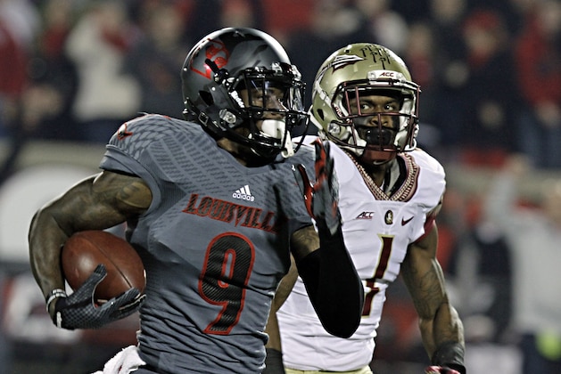 Louisville wide receiver DeVante Parker (9) outruns Florida State defensive back Tyler Hunter (1) on a long pass reception in the first half of their NCAA college football game in Louisville, Ky., Thursday, Oct. 30, 2014. (AP Photo/Garry Jones)