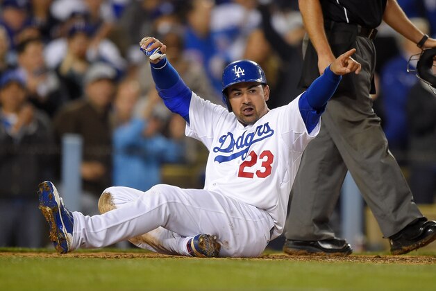 Los Angeles Dodgers' Adrian Gonzalez gestures toward first base after scoring on a single by Howie Kendrick during the sixth inning of a baseball game against the San Diego Padres, Tuesday, April 7, 2015, in Los Angeles. (AP Photo/Mark J. Terrill)