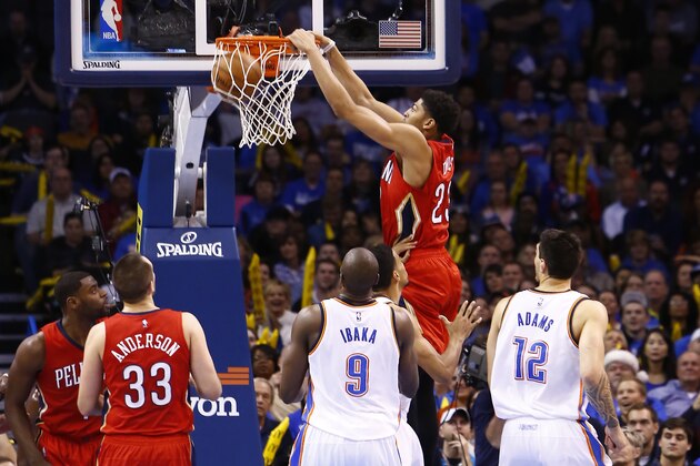 New Orleans Pelicans forward Anthony Davis (23) dunks against the Oklahoma City Thunder in the second quarter of an NBA basketball game in Oklahoma City, Sunday, Dec. 21, 2014. (AP Photo/Alonzo Adams)