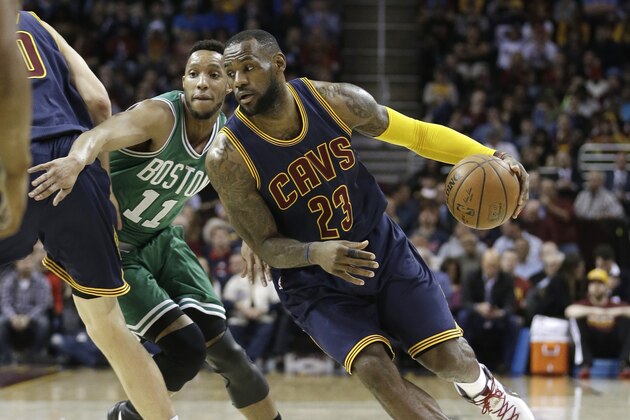 Cleveland Cavaliers' LeBron James (23) drives past Boston Celtics’ Evan Turner (11) during an NBA basketball game Friday, April 10, 2015, in Cleveland. (AP Photo/Tony Dejak)