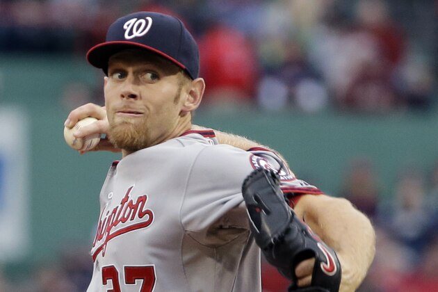Washington Nationals starting pitcher Stephen Strasburg delivers to the Boston Red Sox in the first inning of a baseball game at Fenway Park in Boston, Tuesday, April 14, 2015. (AP Photo/Elise Amendola)