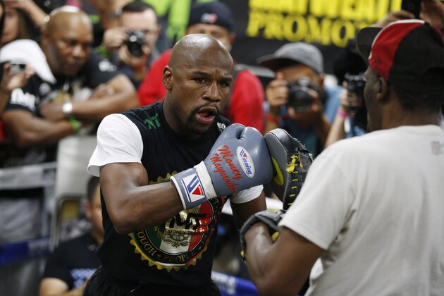 Boxer Floyd Mayweather Jr., left, works out with his uncle Roger Mayweather Tuesday, April 14, 2015, in Las Vegas. Mayweather will face Manny Pacquiao in a welterweight boxing match in Las Vegas on May 2. (AP Photo/John Locher)