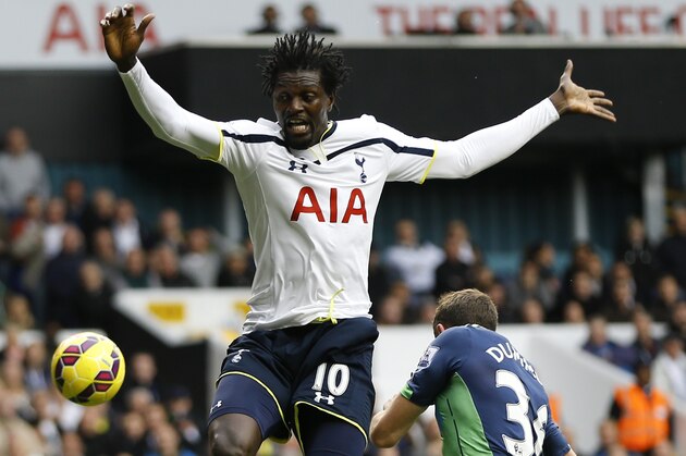 Tottenham's Emmanuel Adebayor vies for the ball with Newcastle's Paul Dummett during the English Premier League soccer match between Tottenham Hotspur and Newcastle United at White Hart Lane stadium in London, Sunday, Oct. 26, 2014. (AP Photo/Kirsty Wigglesworth)