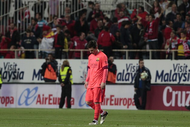 Barcelona's Lionel Messi looks down during the La Liga soccer match against Sevilla at the Ramon Sanchez Pizjuan stadium, in Seville, Spain on Saturday, April 11, 2015. (AP Photo/Angel Fernandez)
