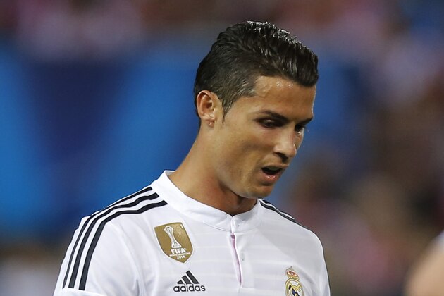 Real Madrid's Cristiano Ronaldo walks back to his position during the Champions League quarterfinal first leg soccer match between Atletico Madrid and Real Madrid at the Vicente Calderon stadium in Madrid, Spain, Tuesday, April 14, 2015. (AP Photo/Andres Kudacki)