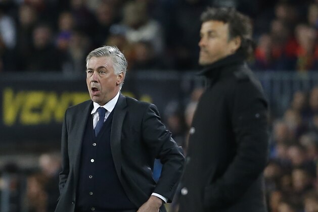 Real Madrid's coach Carlo Ancelotti, left, and Barcelona's head coach Luis Enrique, right, watch during a Spanish La Liga soccer match between FC Barcelona and Real Madrid at Camp Nou stadium, in Barcelona, Spain, Sunday, March 22, 2015. (AP Photo/Emilio Morenatti)