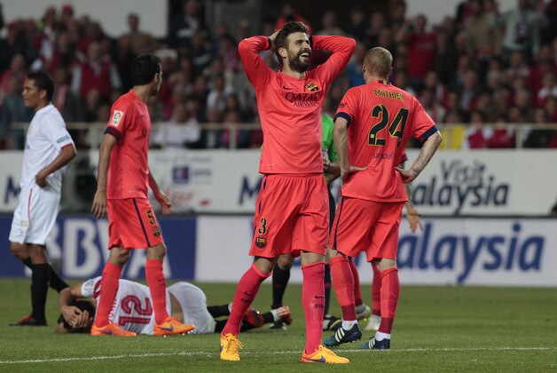 Barcelona's Gerard Pique smiles during their La Liga soccer match against Sevilla at the Ramon Sanchez Pizjuan stadium, in Seville, Spain on Saturday, April 11, 2015. (AP Photo/Angel Fernandez)