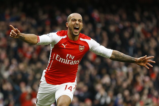 Arsenal's Theo Walcott celebrates scoring a goal during the English Premier League soccer match between Arsenal and Aston Villa at the Emirates stadium in London, Sunday, Feb. 1, 2015. (AP Photo/Kirsty Wigglesworth)