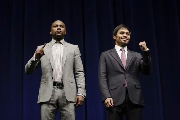 Floyd Mayweather Jr., left, and Manny Pacquiao, of the Philippines, pose for photos during a news conference, Wednesday, March 11, 2015, in Los Angeles. The two are scheduled to fight in Las Vegas on May 2. (AP Photo/Jae C. Hong)