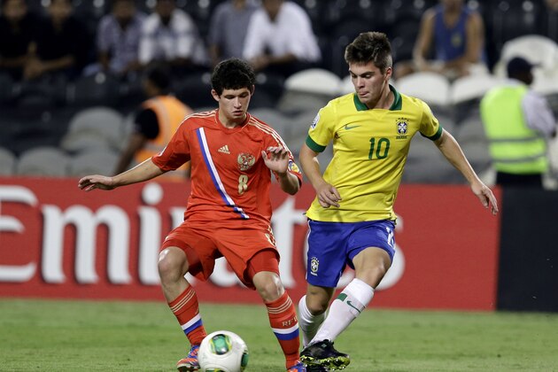 Brazil's Nathan, right, and Russia's Ayaz Guliev fight for the ball during the World Cup U-17 round of 16 soccer match between Brazil and Russia at Zayed sport city in Abu Dhabi, United Arab Emirates, Monday, Oct. 28, 2013. (AP Photo/Hassan Ammar)