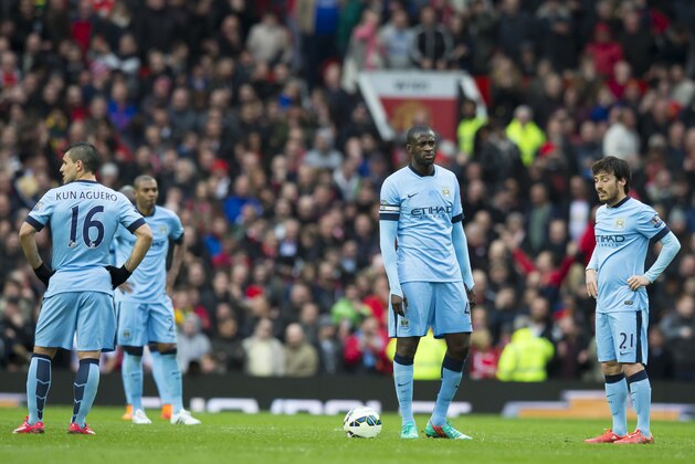 Manchester City's Yaya Toure, centre right, and teammates wait for play to resume after Manchester United's fourth goal during the English Premier League soccer match between Manchester United and Manchester City at Old Trafford Stadium, Manchester, England, Sunday, April 12, 2015. (AP Photo/Jon Super)