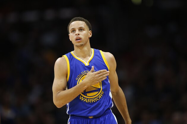 Golden State Warriors' Stephen Curry reacts after making a three pointer while drawing a foul against the Los Angeles Clippers during the first half of an NBA basketball game, Tuesday, March 31, 2015, in Los Angeles. (AP Photo/Danny Moloshok)