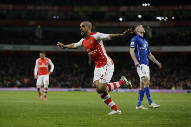 Arsenal's Theo Walcott celebrates scoring his side's second goal during the English Premier League soccer match between Arsenal and Leicester City at the Emirates Stadium in London, Tuesday, Feb. 10, 2015. (AP Photo/Matt Dunham)