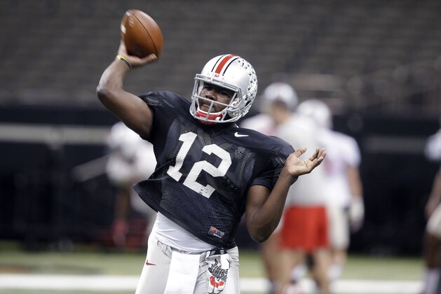 Ohio State quarterback Cardale Jones (12) passes during practice at the Mercedes-Benz Superdome in New Orleans, Monday, Dec. 29, 2014. They will square off against Alabama in the Allstate Sugar Bowl NCAA football game, which will be played Jan. 1, 2015. (AP Photo/Gerald Herbert)