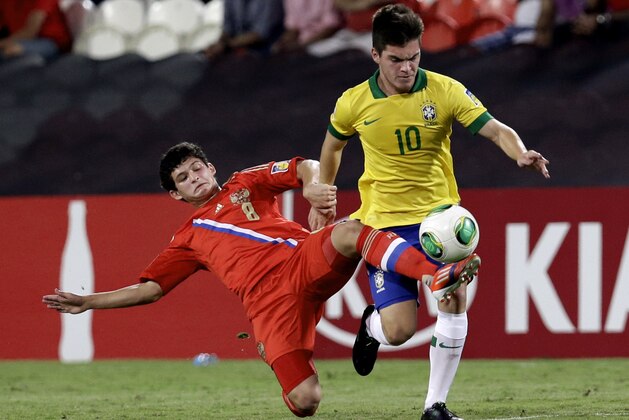 Brazil's Nathan, right, and Russia's Ayaz Guliev fight for the ball during the World Cup U-17 round of 16 soccer match between Brazil and Russia at Zayed sport city in Abu Dhabi, United Arab Emirates, Monday, Oct. 28, 2013. (AP Photo/Hassan Ammar)