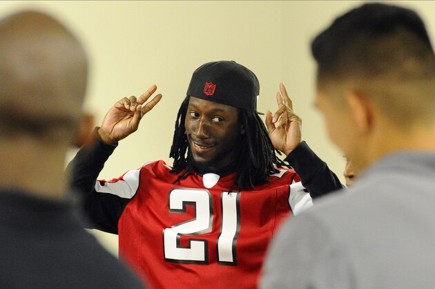 Atlanta Falcons cornerback Desmond Trufant reacts before providing a catered Thanksgiving meal to 125 men from the Shepherd’s Inn, the men’s facility of the Atlanta Mission on Monday, Nov. 24, 2014, in Atlanta. Trufant and team members greeted the men with high-fives, served food, danced, and signed autographs as part of their community outreach. The Atlanta Mission provides overnight shelter, job attainment programming, long-term residential discipleship programming and transitional housing for more than 950 homeless men, women and children daily. (AP Photo/David Tulis)