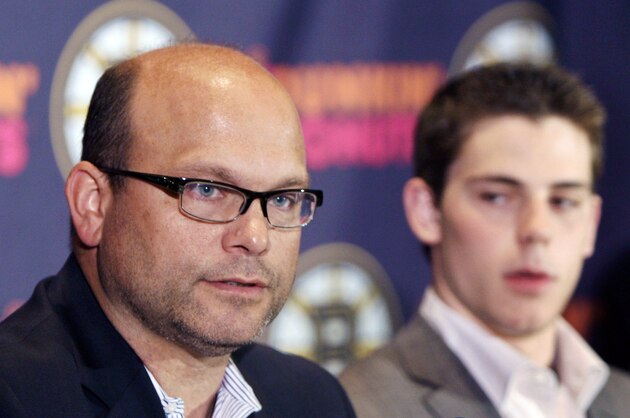 Boston Bruins general manager Peter Chiarelli, left, speaks during a news conference as the newest member of the Boston Bruins center Tyler Seguin, right, the No. 2 pick overall in last week's NHL draft looks on, Tuesday, June 29, 2010, in Boston. (AP Photo/Bizuayehu Tesfaye)