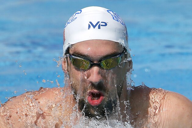Michael Phelps swims laps during a practice session, Wednesday, April 15, 2015, in Mesa, Ariz. The 18-time Olympic champion will compete in the Area Pro Swim Series after serving a six-month suspension for DUI. (AP Photo/Matt York)