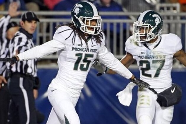 Michigan State cornerback Trae Waynes (15) celebrates with Kurtis Drummond (27) after intercepting a pass intended for Penn State wide receiver Chris Godwin (12) in the end zone for a touchback during the second half of an NCAA college football game in State College, Pa., Saturday, Nov. 29, 2014. (AP Photo/Gene J. Puskar)