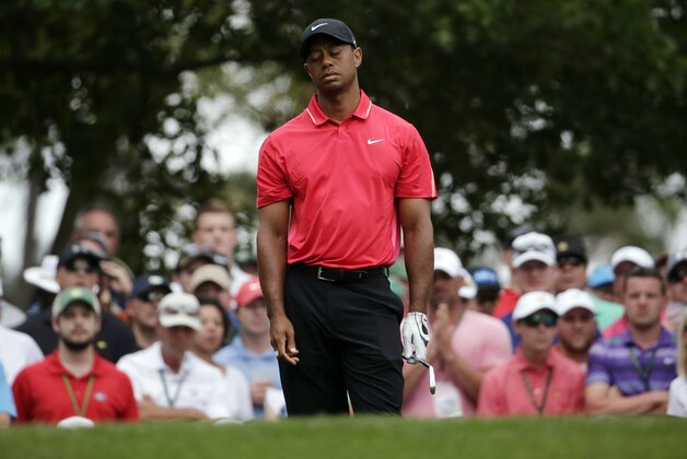 Tiger Woods reacts after teeing off on the fourth hole during the fourth round of the Masters golf tournament Sunday, April 12, 2015, in Augusta, Ga. (AP Photo/Chris Carlson)
