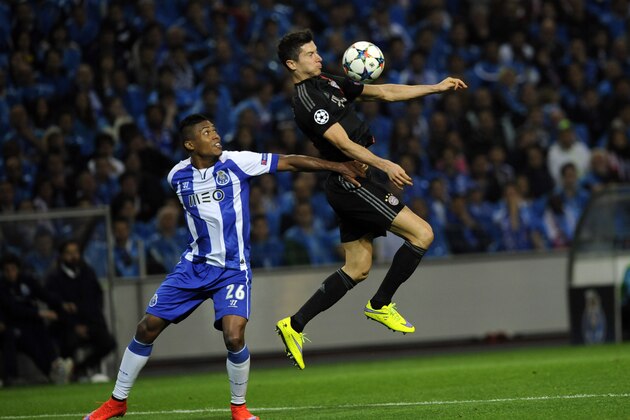 Porto's Alex Sandro , left, fights for the ball with Bayern's Robert Lewandowski during the Champions League quarterfinal first leg soccer match between FC Porto and Bayern Munich at the Dragao Stadium in Porto, Portugal, Wednesday, April 15, 2015. (AP Photo/Paulo Duarte)