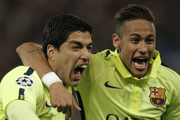 Barcelona's Luis Suarez, left, celebrates with Neymar after scoring his team's second goal during the quarterfinal first leg Champions League soccer match between Paris Saint Germain and Barcelona at the Parc des Princes stadium in Paris, France, Wednesday, April 15, 2015. (AP Photo/Christophe Ena)