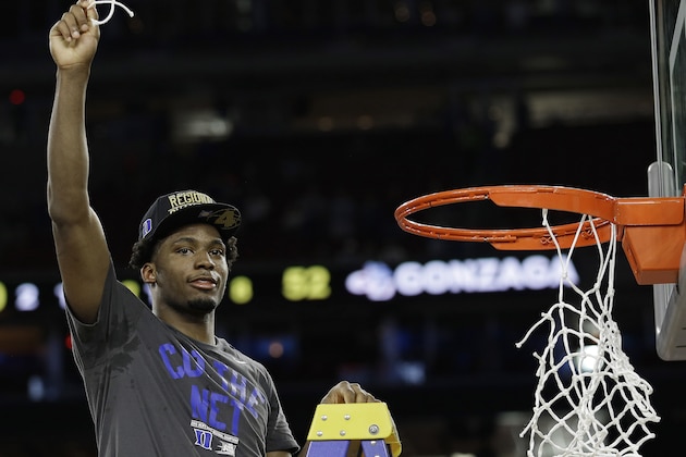 Duke's Justise Winslow holds part of the net after a college basketball regional final game against Gonzaga in the NCAA Tournament Sunday, March 29, 2015, in Houston. Duke won 66-52 to advance to the Final Four. (AP Photo/David J. Phillip)