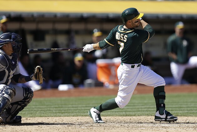 Oakland Athletics' Cody Ross swings for an RBI single off Seattle Mariners' J.A. Happ in the seventh inning of a baseball game Saturday, April 11, 2015, in Oakland, Calif. (AP Photo/Ben Margot)