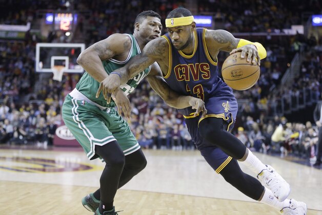 Cleveland Cavaliers' LeBron James drives on Boston Celtics' Marcus Smart in an NBA basketball game Tuesday, March 3, 2015, in Cleveland. (AP Photo/Mark Duncan)