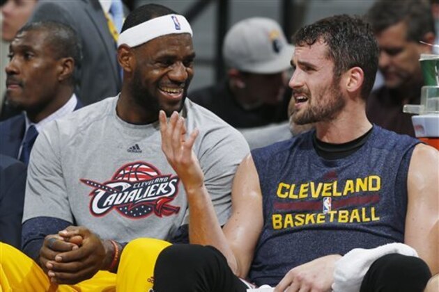 FILE - In this Nov. 7, 2014, file photo, Cleveland Cavaliers forwards LeBron James, left, and Kevin Love joke with each other on the bench in the fourth quarter of the Cavaliers' 110-101 victory over the Denver Nuggets in an NBA basketball game in Denver. Cavaliers star LeBron James is choosing not to clarify any posts he made in recent days on Twitter, including a message that seemed to be aimed at teammate Kevin Love. (AP Photo/David Zalubowski, File)