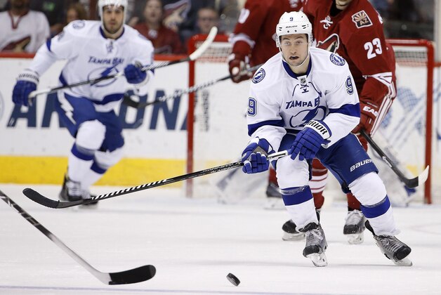 Tampa Bay Lightning's Tyler Johnson (9) skates to the puck during the first period of an NHL hockey game against the Arizona Coyotes Saturday, Feb. 21, 2015, in Glendale, Ariz. (AP Photo/Ross D. Franklin)