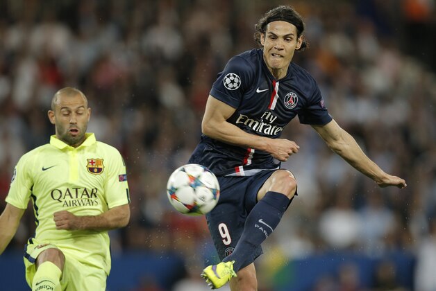 PSG's Edinson Cavani, right, shoots in front of Barcelona's Javier Mascherano during the quarterfinal first leg Champions League soccer match between Paris Saint Germain and Barcelona at the Parc des Princes stadium in Paris, France, Wednesday, April 15, 2015. (AP Photo/Christophe Ena)