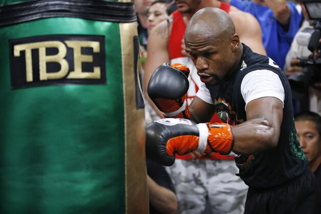 Floyd Mayweather Jr. hits a heavy bag Tuesday, April 14, 2015, in Las Vegas. Mayweather is scheduled to face Manny Pacquiao in a welterweight boxing match in Las Vegas on May 2. (AP Photo/John Locher)