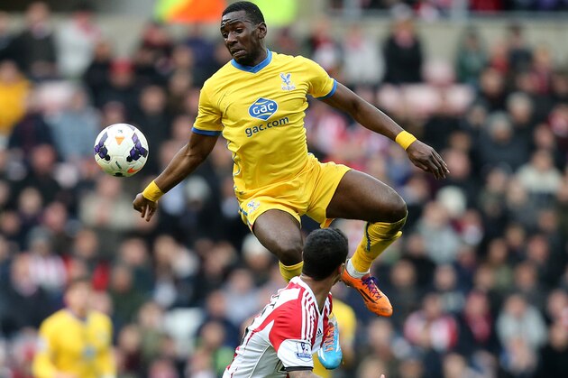 Crystal Palace's Yannick Bolasie, top, vies for the ball with Sunderland's Liam Birdcutt, bottom, during their English Premier League soccer match at the Stadium of Light, Sunderland, England, Saturday, March 15, 2014. (AP Photo/Scott Heppell)