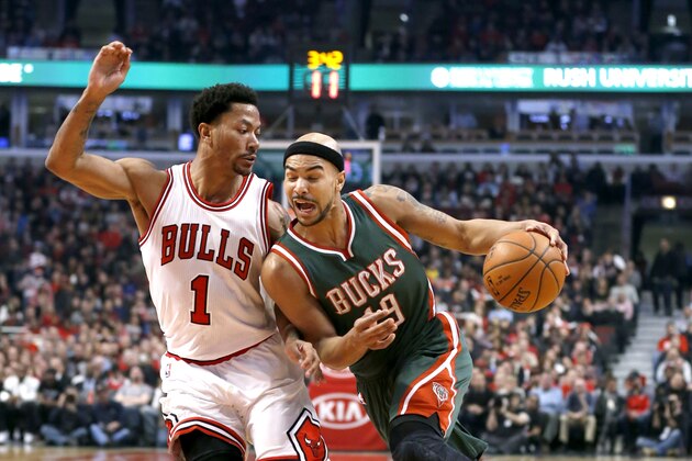 Milwaukee Bucks guard Jerryd Bayless (19) drives on Chicago Bulls guard Derrick Rose (1) during the first half of an NBA basketball game Monday, Feb. 23, 2015, in Chicago. (AP Photo/Charles Rex Arbogast)