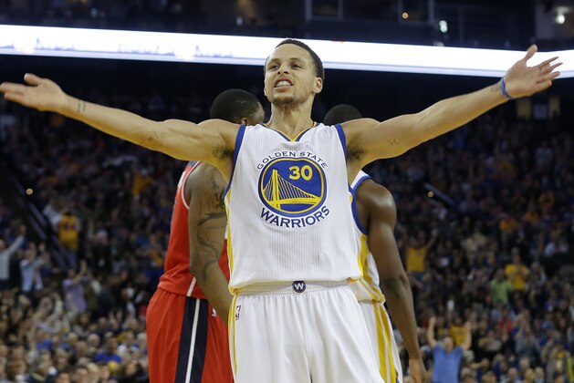 Golden State Warriors guard Stephen Curry (30) celebrates after scoring against the Washington Wizards during the second half of an NBA basketball game in Oakland, Calif., Monday, March 23, 2015. (AP Photo/Jeff Chiu)